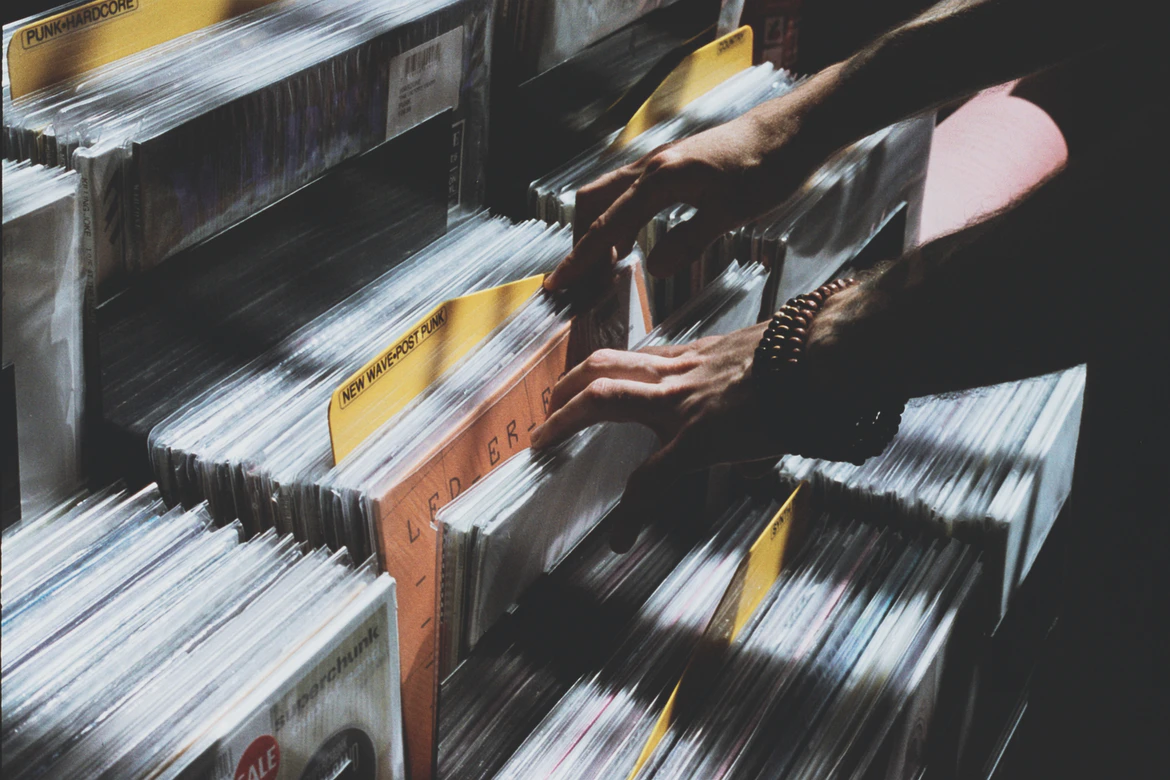 Person browsing records. Photo by Florencia Viadana, courtesy of Unsplash
